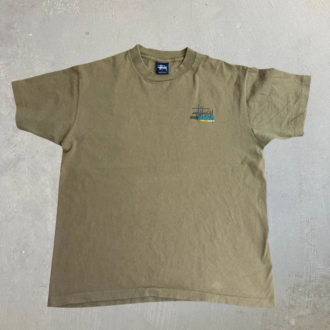 J- Vintage Stussy International Text Made In USA Single Stitch Tee - L sold by HG Vintage