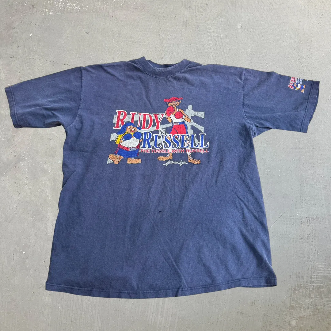 J- Vintage Platinum FUBU Fat Albert Rudy Vs Russell Graphic Tee - XL sold by HG Vintage