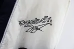 Z - Vintage 90s Reebok Embroidered Script Nylon Windbreaker sold by HG Vintage