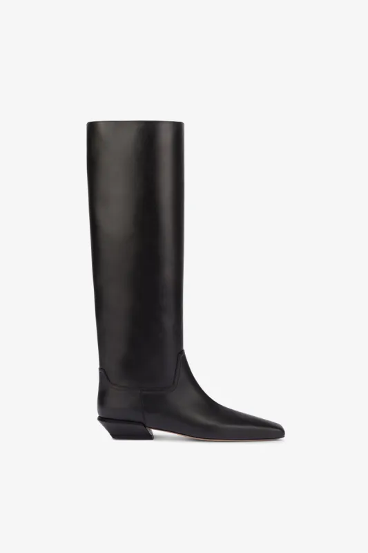 Knee-high boots in smooth black leather sold by Paris Texas