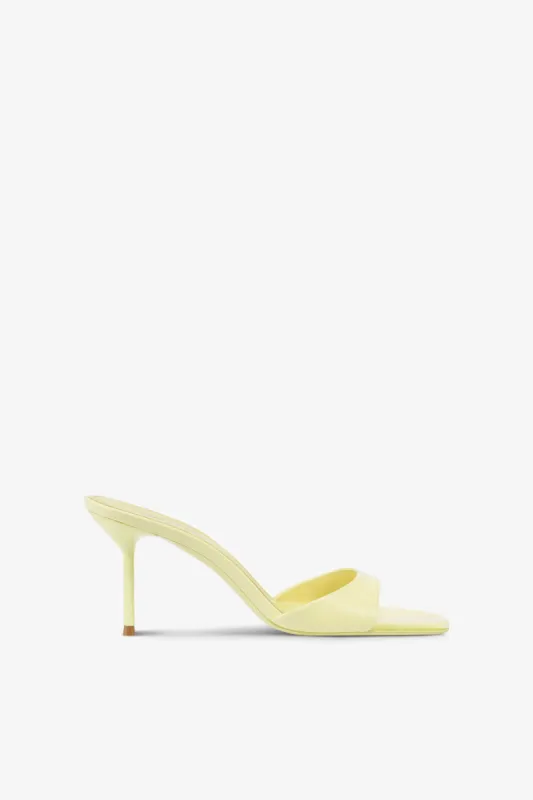 Mules in light yellow patent leather sold by Paris Texas