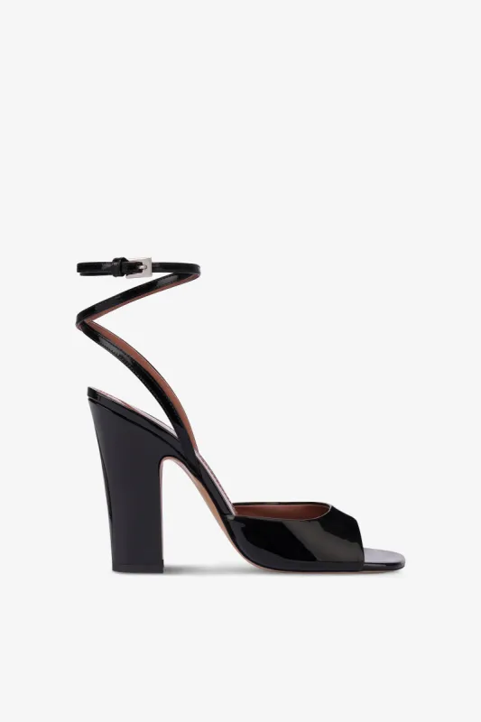 Sandals in black patent leather sold by Paris Texas