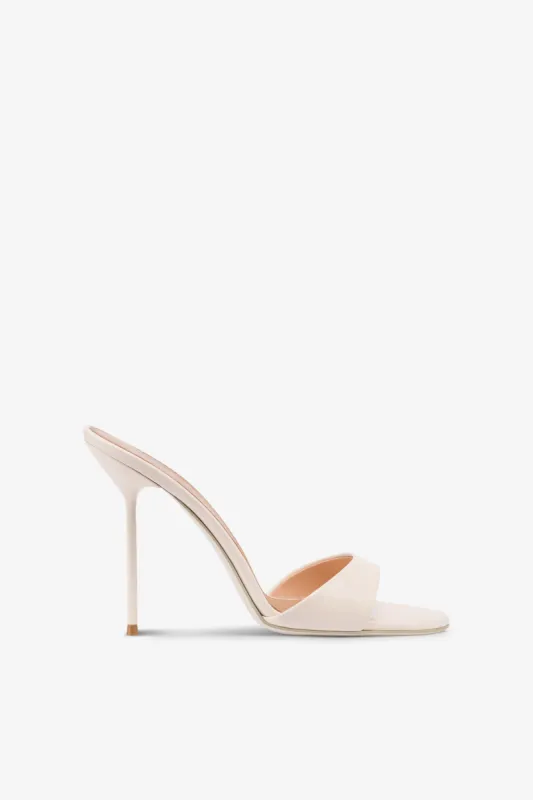 Mules in ivory patent leather sold by Paris Texas