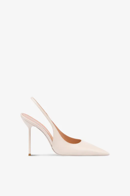 Slingbacks in ivory patent leather sold by Paris Texas