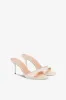 Mules in ivory patent leather sold by Paris Texas