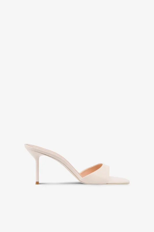 Mules in ivory patent leather sold by Paris Texas