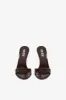 Mules in chocolate patent leather sold by Paris Texas