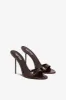Mules in chocolate patent leather sold by Paris Texas