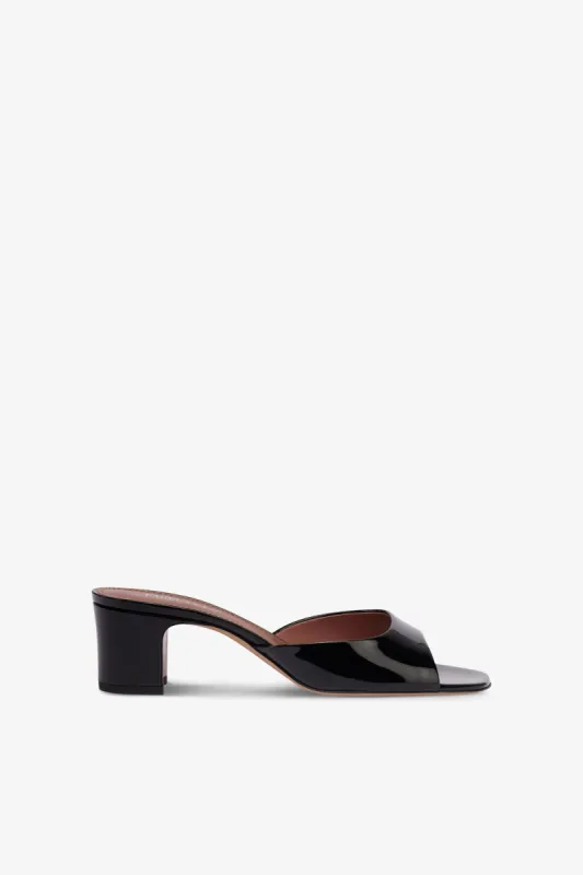 Mules in black patent leather sold by Paris Texas