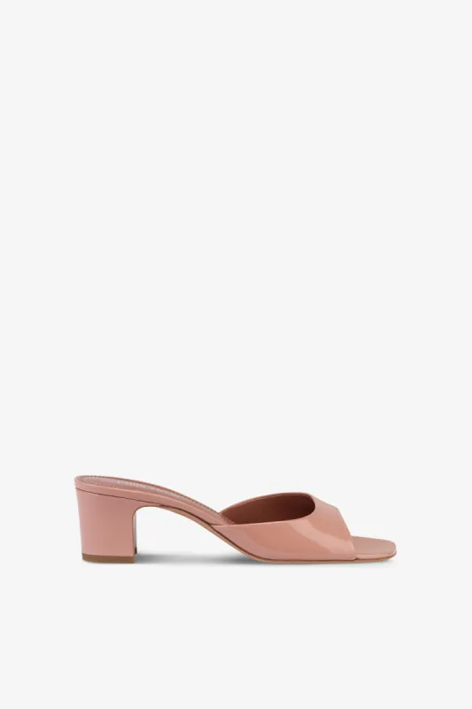 Mules in dark phard patent leather sold by Paris Texas