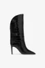 Boots in black croco-embossed leather sold by Paris Texas