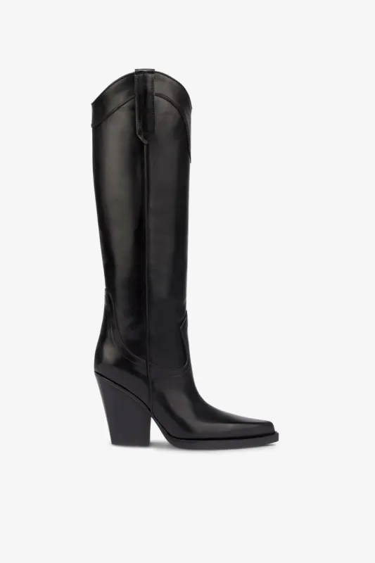 Pointed knee-high boots in black shiny vintage leather sold by Paris Texas
