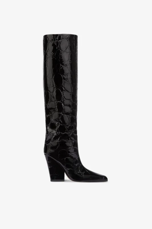 Knee-high boots in black patent soft croco-embossed leather sold by Paris Texas