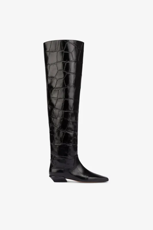 Over-the-knee boots in black croco-embossed leather sold by Paris Texas