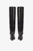 Tall, knee-high boots in shiny black vintage leather sold by Paris Texas