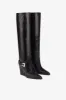 Tall, knee-high boots in shiny black vintage leather sold by Paris Texas