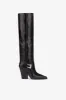 Tall, knee-high boots in shiny black vintage leather sold by Paris Texas