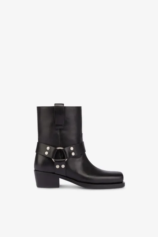 Square-toe ankle boots in smooth black leather sold by Paris Texas