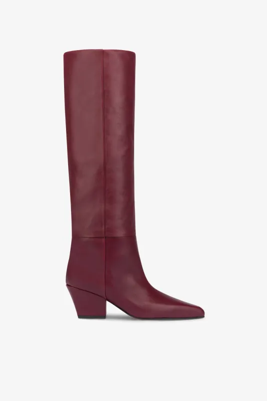 Knee-high, long pointed boot in supple rouge noir leather sold by Paris Texas
