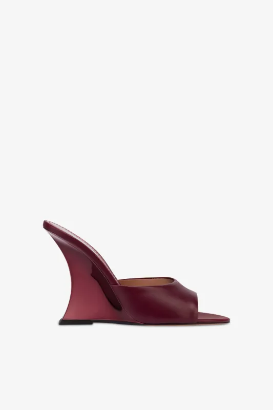 Mules in rouge noir leather sold by Paris Texas