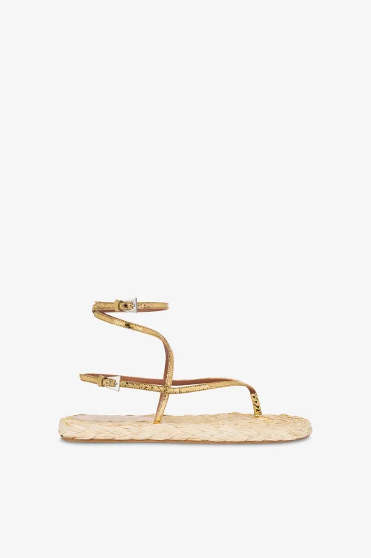 Lace-up sandals in natural raffia and gold metallic python-print leather sold by Paris Texas