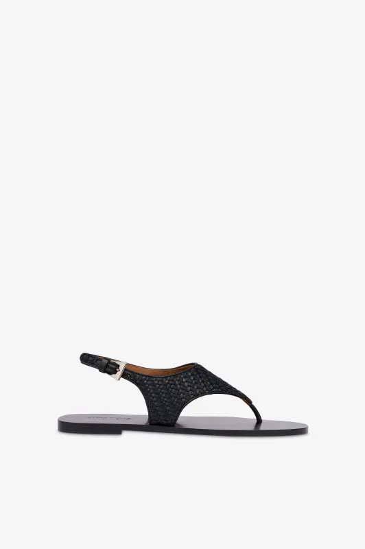 Sandals in natural raffia and black leather sold by Paris Texas