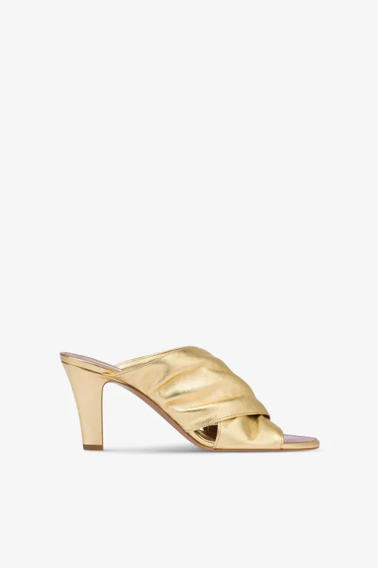 Mules in gold metallic leather sold by Paris Texas