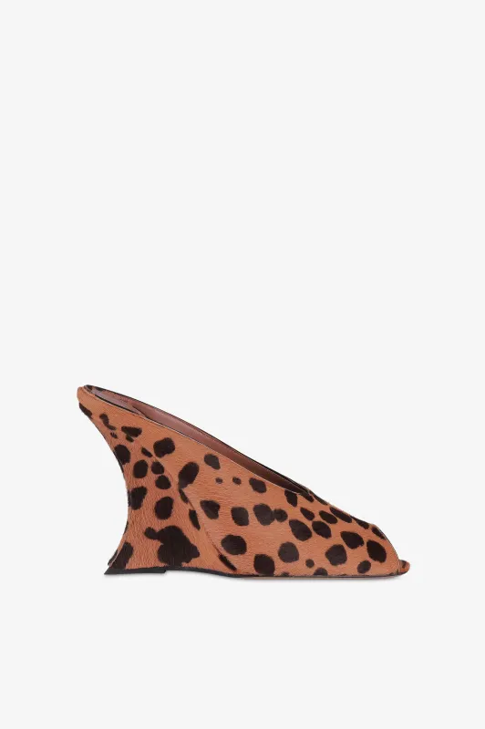 Open-toe sabots in caramel and dark brown printed cowhide sold by Paris Texas