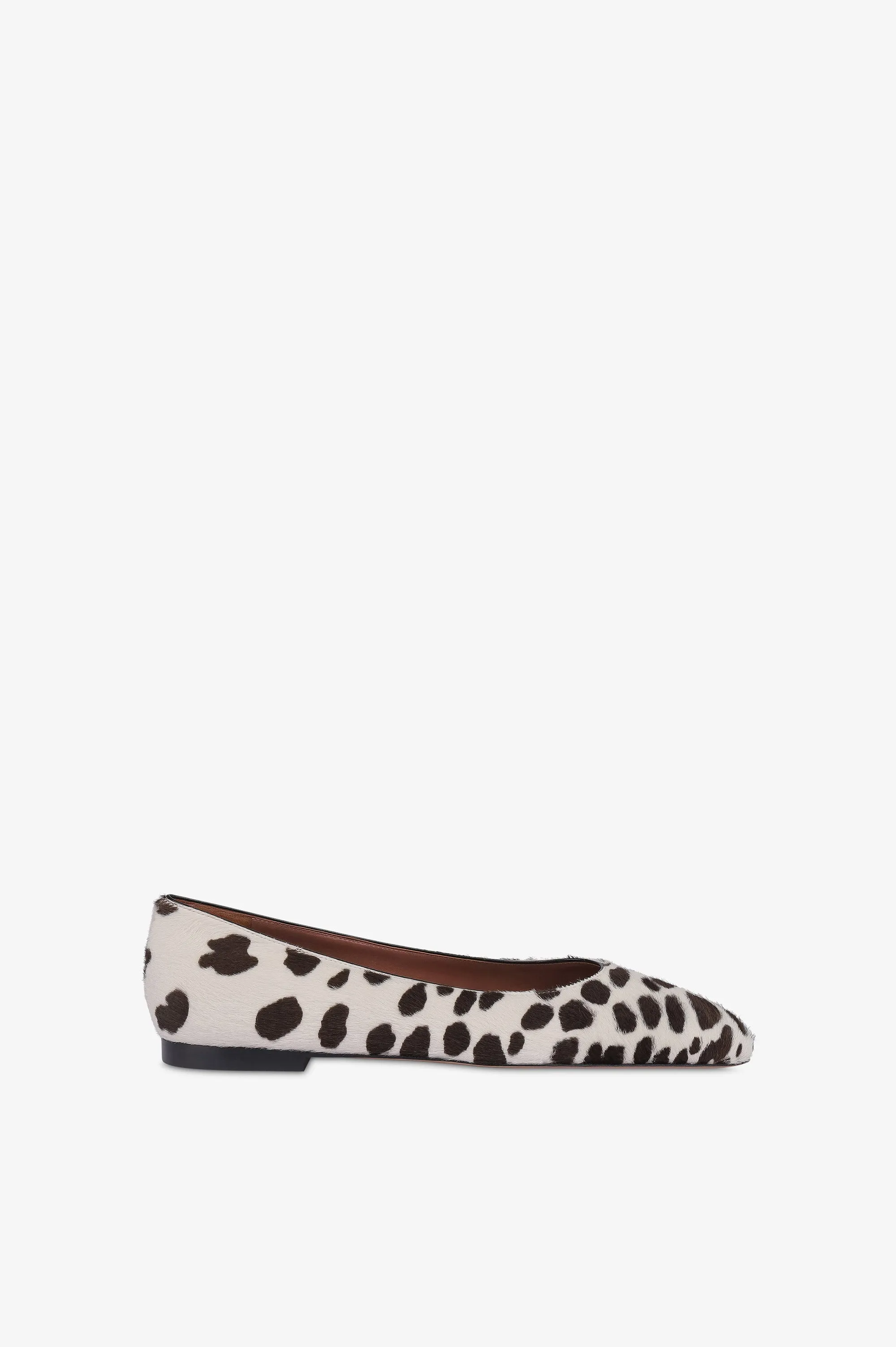 Ballet flats in white and dark brown printed cowhide sold by Paris Texas
