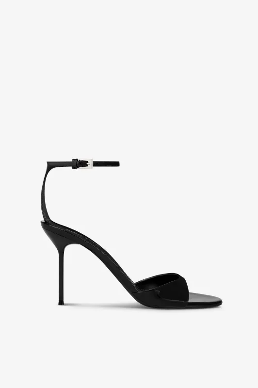 Sandals in black patent leather sold by Paris Texas