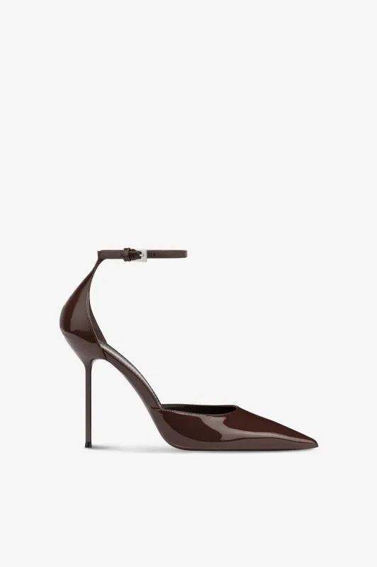 Ankle-strap pumps in ebony patent leather sold by Paris Texas