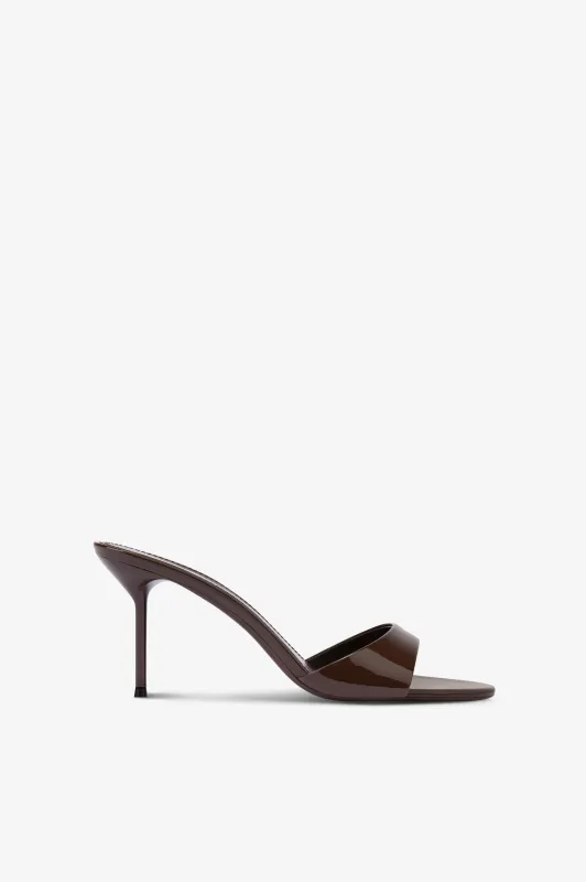 Mules in ebony patent leather sold by Paris Texas