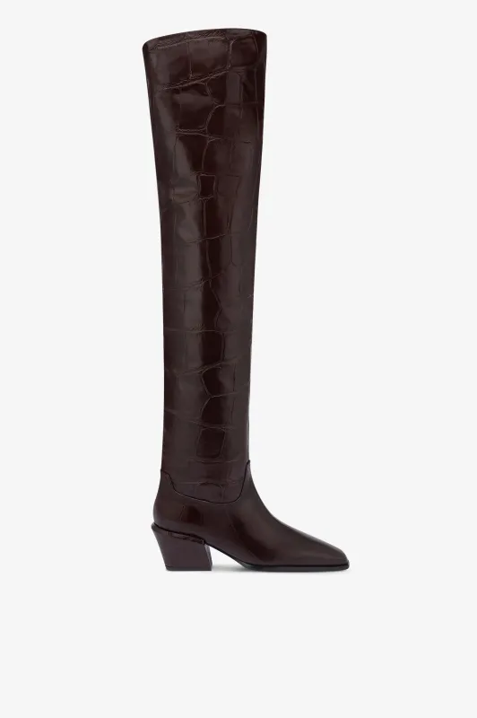 Over-the-knee boots in ebony croco-embossed leather sold by Paris Texas
