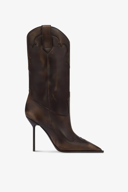 Boots in ebony brushed leather. sold by Paris Texas