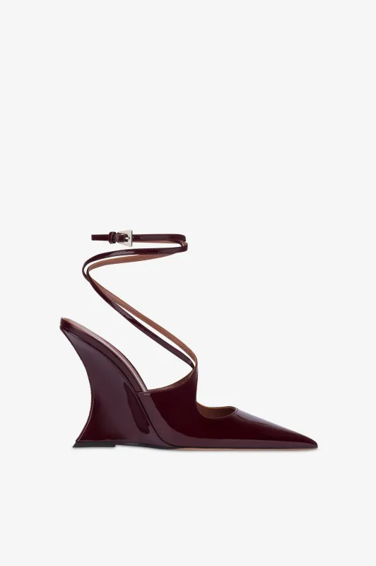 Ankle-strap pumps in rouge noir patent leather. sold by Paris Texas