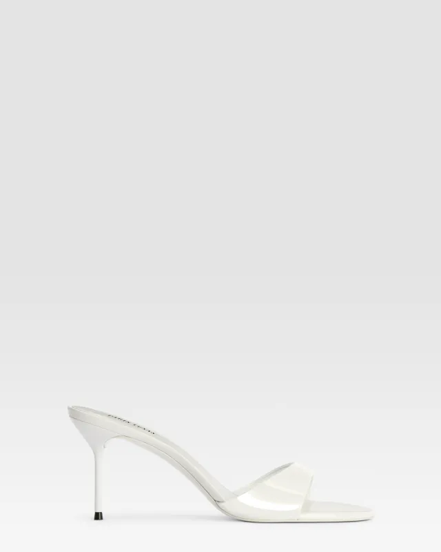 Mules in optic white patent leather sold by Paris Texas