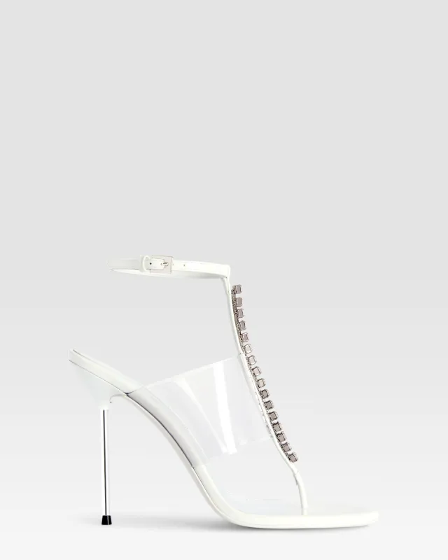 T-strap sandals in optic white patent leather with stud detailing sold by Paris Texas