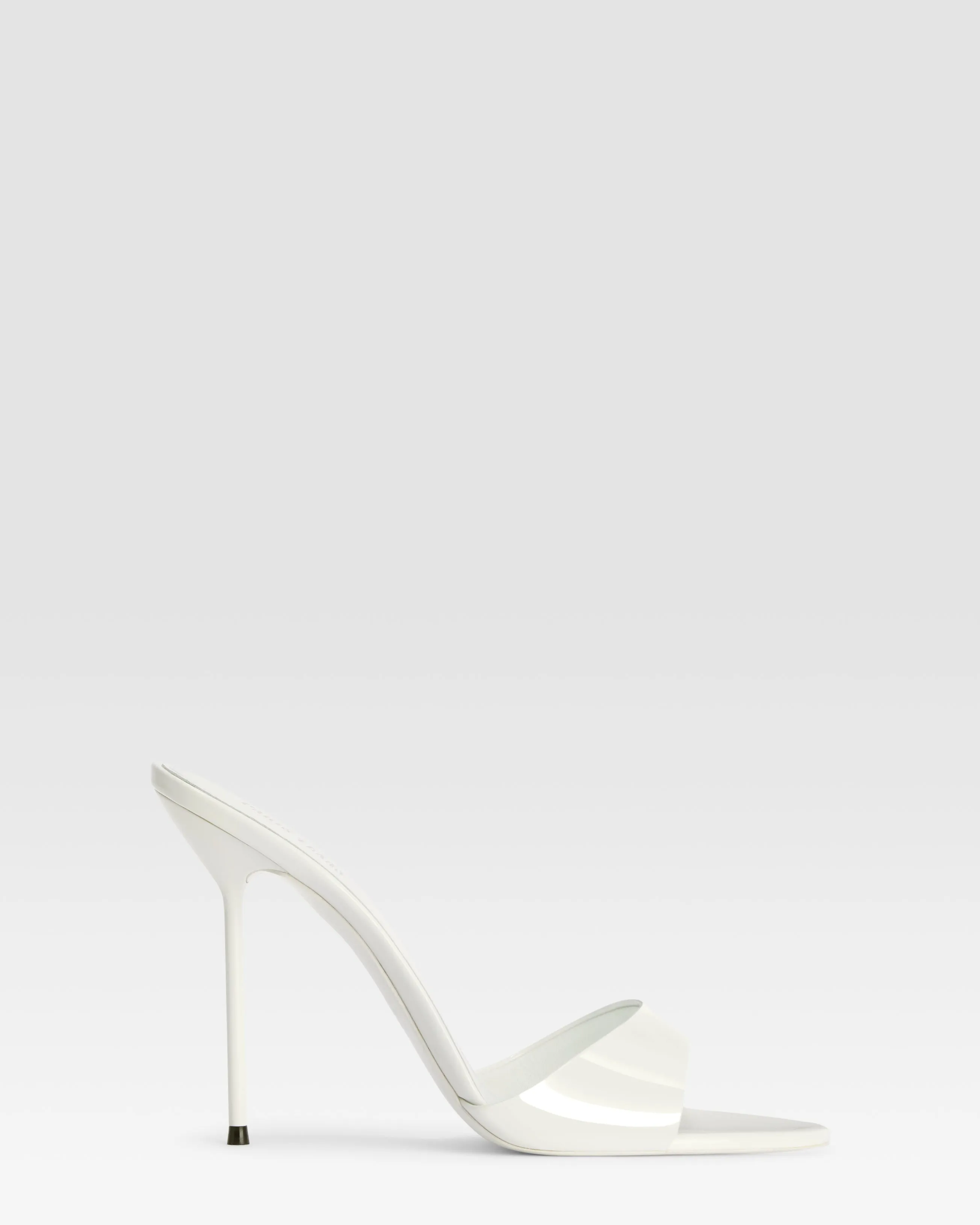Mules in optic white patent leather sold by Paris Texas