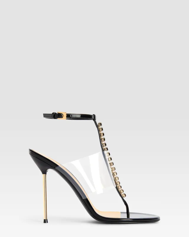 T-strap sandals in black patent leather with stud detailing sold by Paris Texas