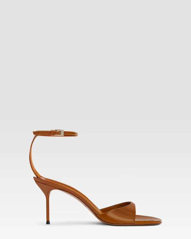 Ankle-strap sandals in coffee patent leather sold by Paris Texas