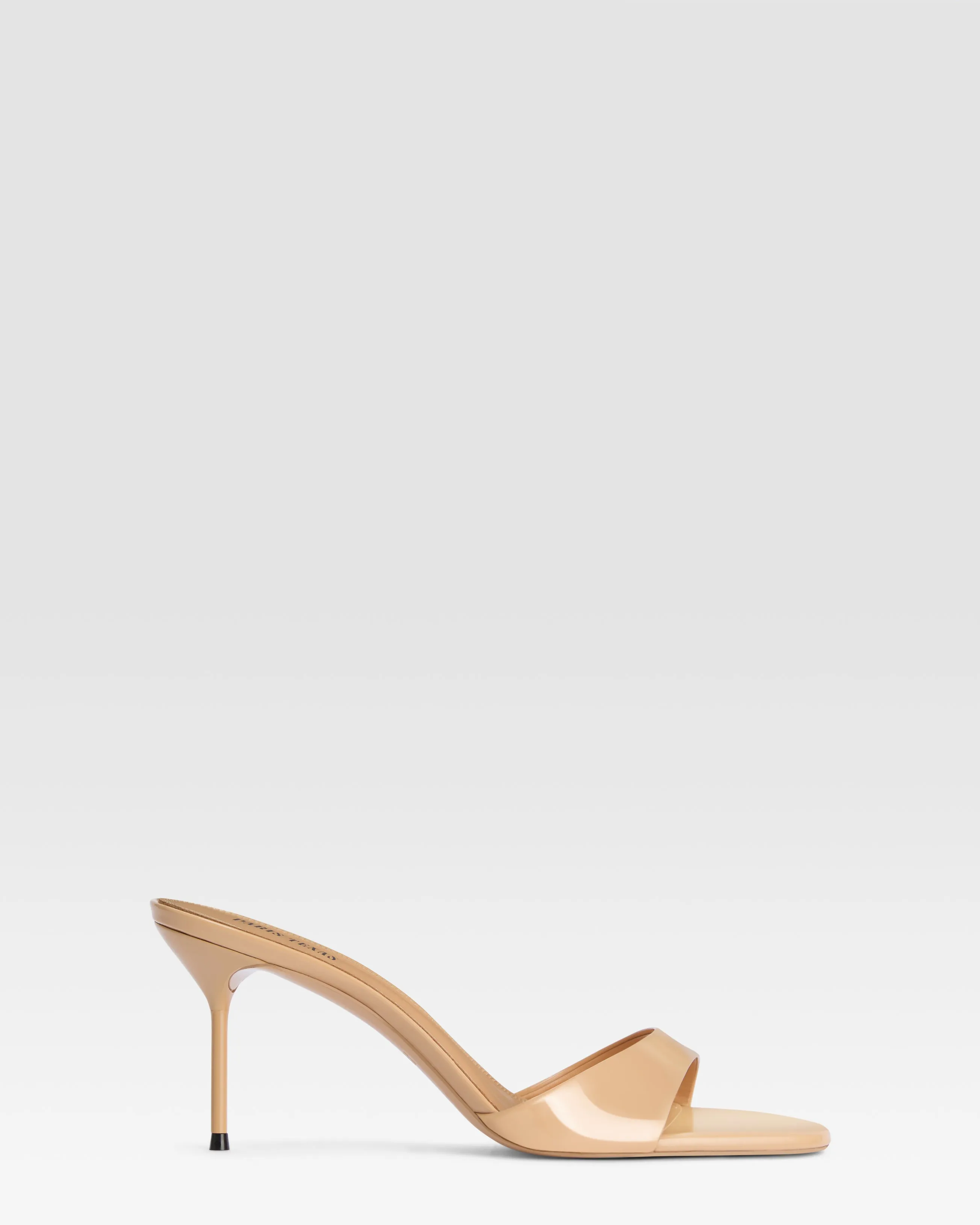 Mules in honey patent leather sold by Paris Texas