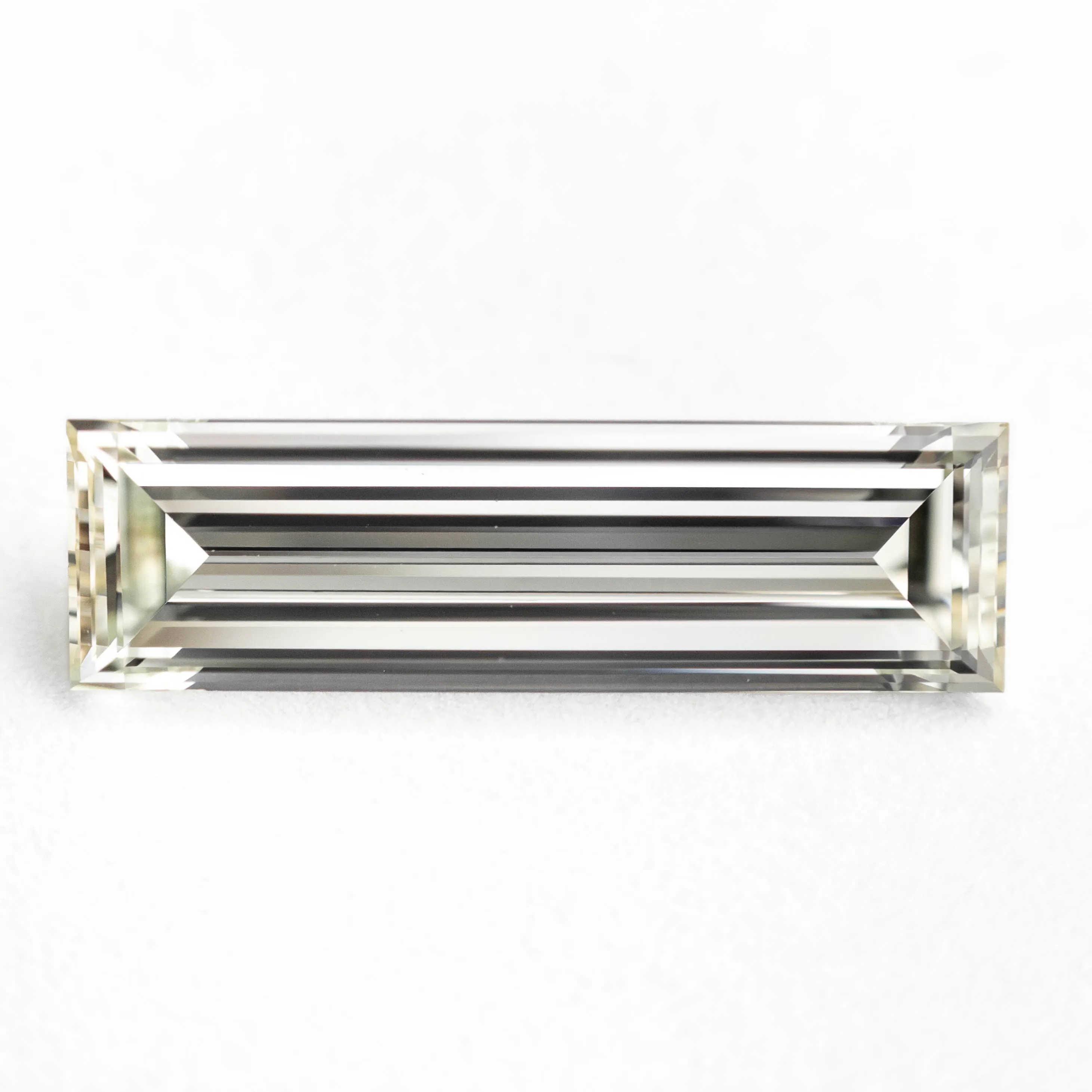 1.31ct 13.12x3.81x2.38mm VS1 L-M Baguette Step Cut 24700-01 sold by Young In The Mountains