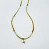grossular garnet with diamond and gold starburst sold by Theodosia