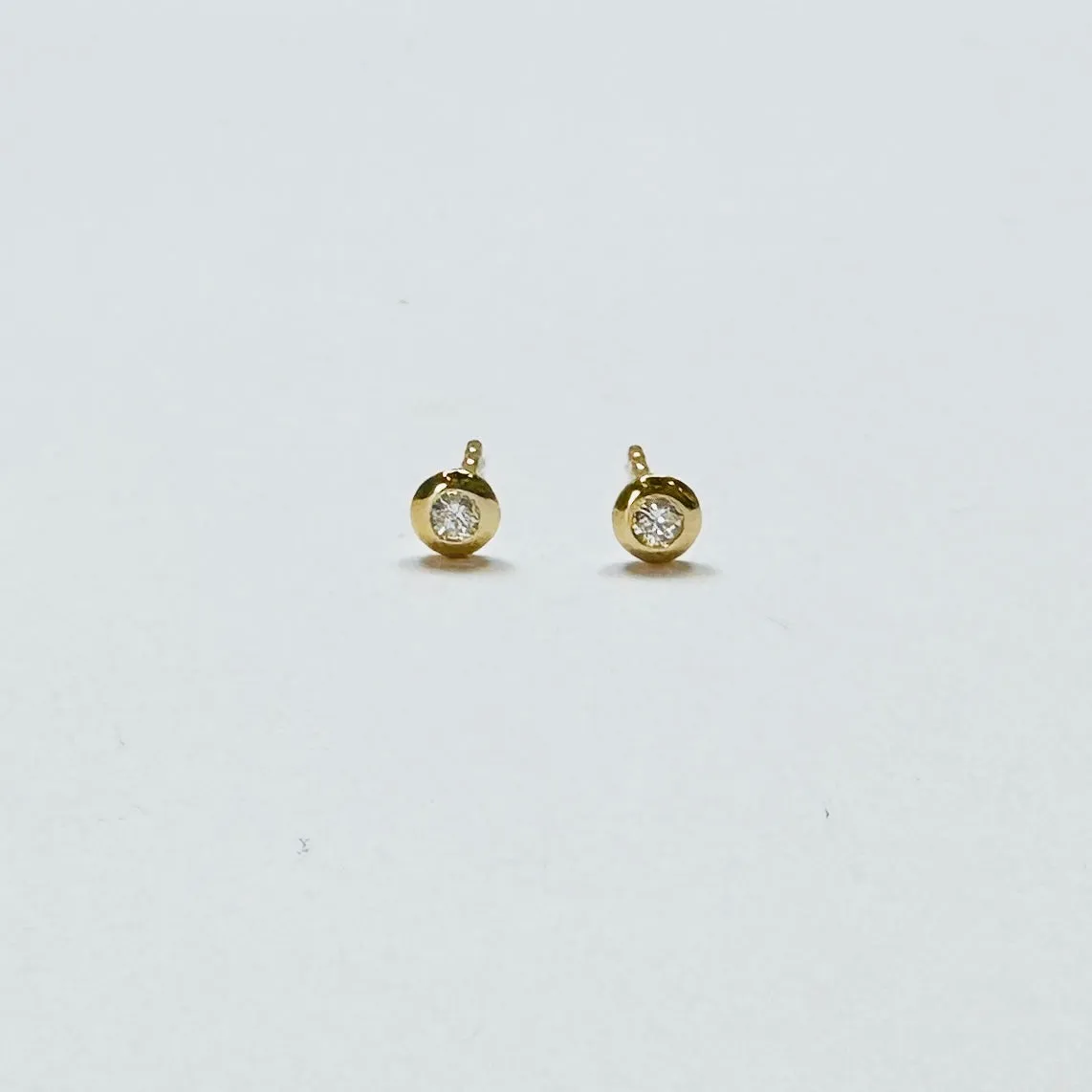 flat bezel diamond studs sold by Theodosia