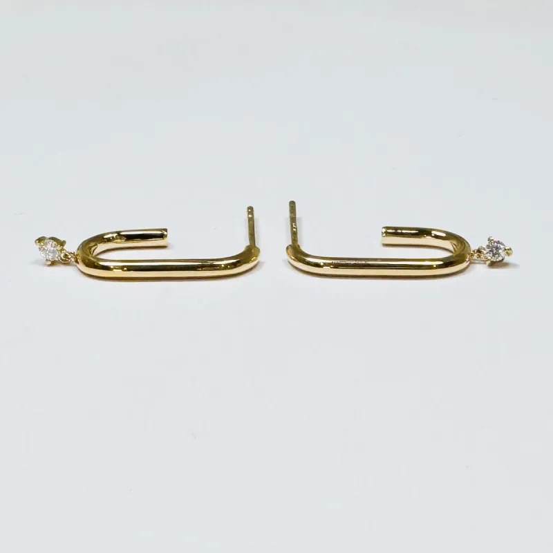 elongated gold hoops sold by Theodosia