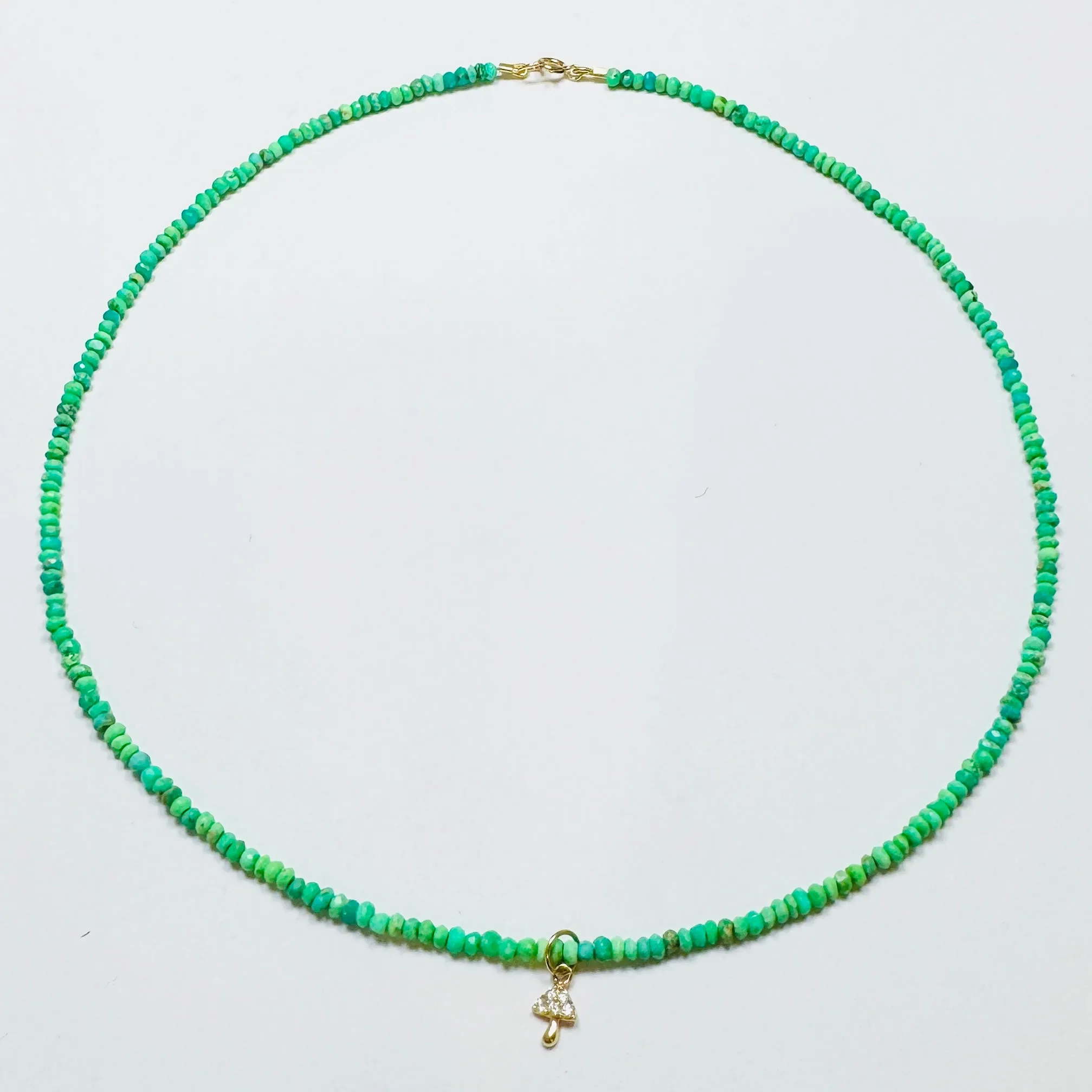 delicate neon turquoise necklace with mushroom charm sold by Theodosia