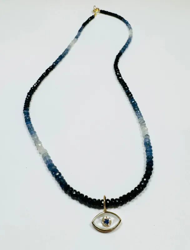 shaded blue sapphire necklace with evil eye charm sold by Theodosia