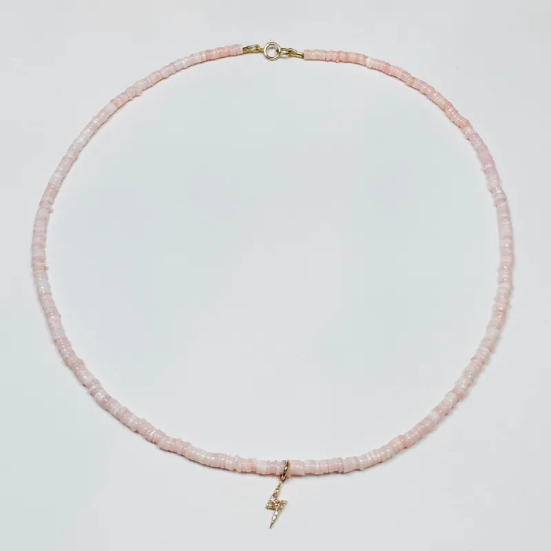 delicate conch necklace with lightning bolt charm sold by Theodosia