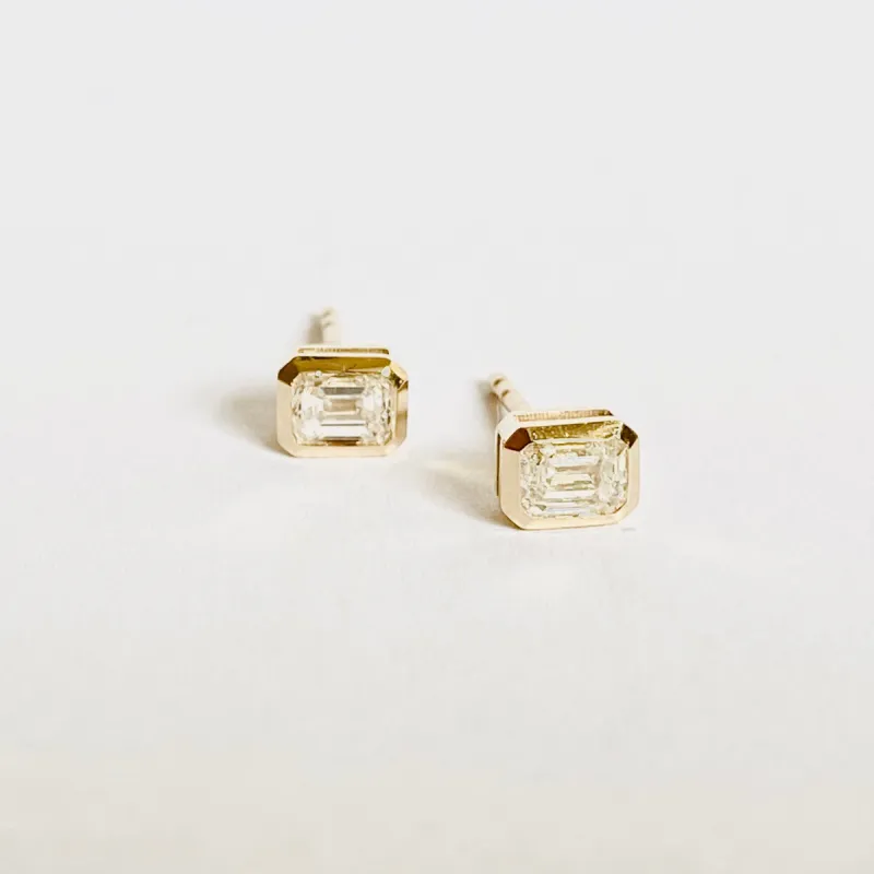 14 k gold bezel set emerald cut diamond studs sold by Theodosia