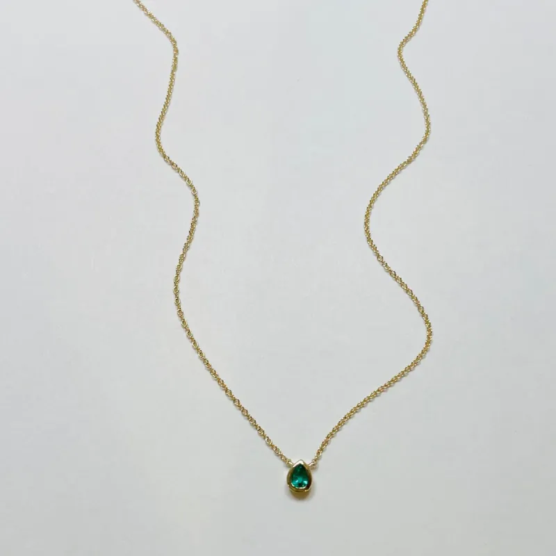 bezel set pear shaded emerald necklace sold by Theodosia